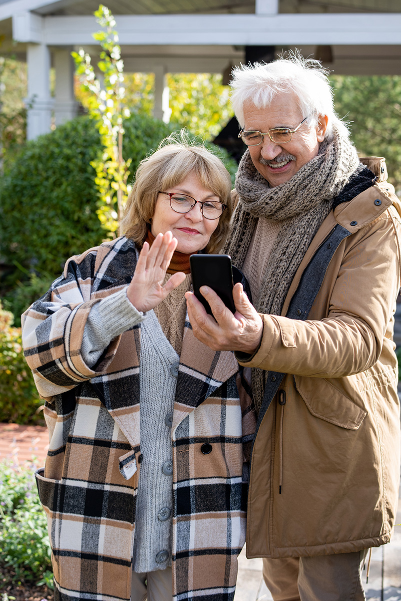 A happy retired couple using a smartphone to take a selfie